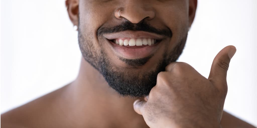 close up of smiling biracial man touch bristle picture id1227113422