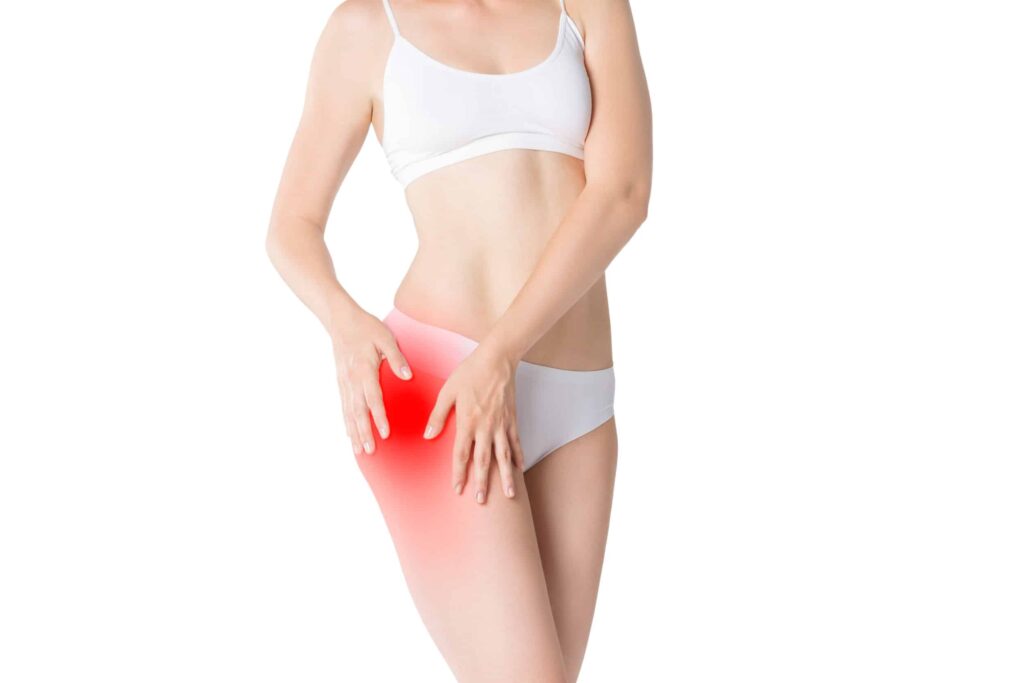 Woman with pain in thigh isolated on white background